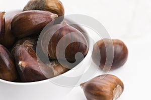 Bowl of chestnuts on a white background