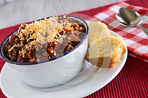 Bowl of Chili Comfort Food With Corn Bread Muffin Horizontal photo