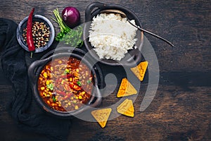 Bowl of chili con carne with rice and toppings