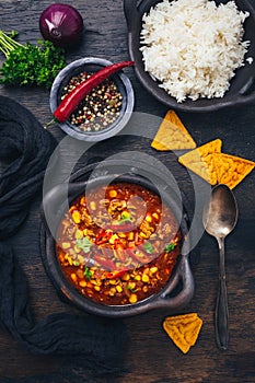 Bowl of chili con carne with rice and toppings