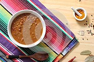 Bowl of Chili With Pinto Beans on Table With Peppers and Dry Beans in Background