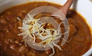 Bowl of Chili With Pinto Beans on Table With Peppers and Dry Beans in Background