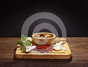 Bowl of chinese soup against black