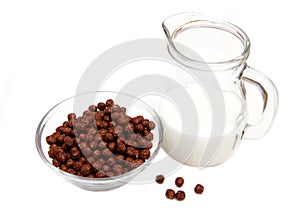 Bowl with chocolate cereals and milk jug