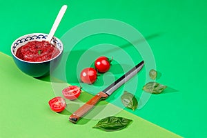 Bowl of chopped tomatoes on green table