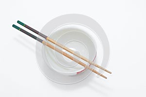 bowl with chopsticks isolated on a white background
