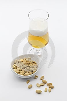 Bowl of cocoa and glass of beer on white background