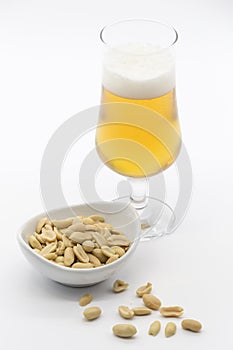 Bowl of cocoa and glass of beer on white background