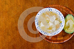 A bowl of Colombian mote de queso, thick yam soup with onion, garlic, peasant cheese cubes