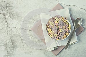 Bowl of colorful cereals and spoon