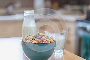 Bowl of colorful children`s cereal and milk isolated on wood table with Text space