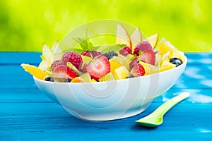 Bowl of colourful tasty tropical fruit salad