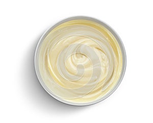 Bowl of condensed milk isolated on white background, top view