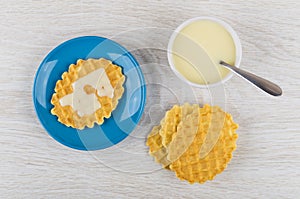 Bowl with condensed milk, wafer cookies with milk in saucer