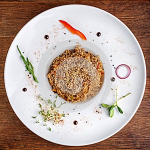 Bowl of cooked long grain brown rice decorated with sesame