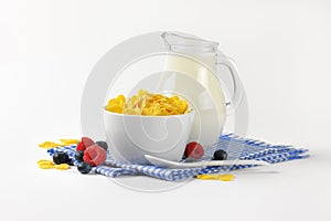 Bowl of corn flakes and jug of milk