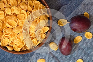 Bowl of cornflakes on the table, top view. Healthy crispy breakfast snack