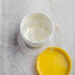 Bowl with cosmetic cream on the marble table