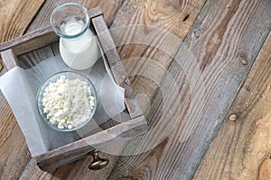 Bowl of cottage cheese with bottle of milk