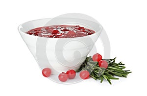 Bowl of cranberry sauce with rosemary on white