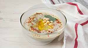 A bowl of creamy hummus with olive oil.