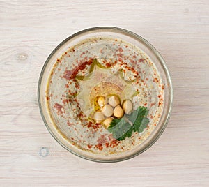 A bowl of creamy hummus with olive oil.