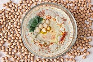 A bowl of creamy hummus with olive oil.