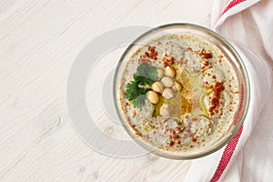 A bowl of creamy hummus with olive oil.