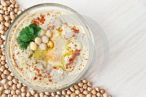 A bowl of creamy hummus with olive oil.