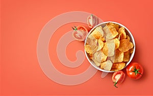 Bowl of crispy potato chips or crisps with tomato flavor on red background