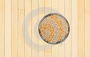 Bowl of crispy rice breakfast cereal on a wood placemat