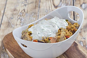 Bowl with curry flavored rice chicken and vegetables