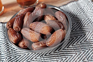 Bowl of dates fruit and glass of tea