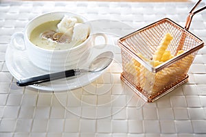 Bowl of delicious homemade cream of mushroom soup. Mushroom cream soup on a table. Bowl of fresh homemade mushroom soup on wooden