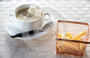 Bowl of delicious homemade cream of mushroom soup. Mushroom cream soup on a table. Bowl of fresh homemade mushroom soup on wooden