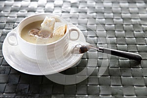 Bowl of delicious homemade cream of mushroom soup. Mushroom cream soup on a table. Bowl of fresh homemade mushroom soup on wooden