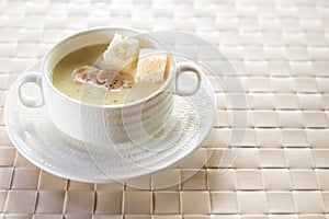 Bowl of delicious homemade cream of mushroom soup. Mushroom cream soup on a table. Bowl of fresh homemade mushroom soup on wooden