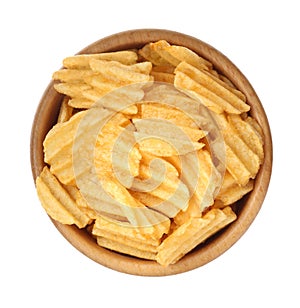 Bowl with delicious ridged potato chips isolated on white, top view