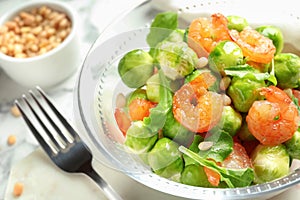 Bowl of delicious salad with Brussels sprouts and shrimps