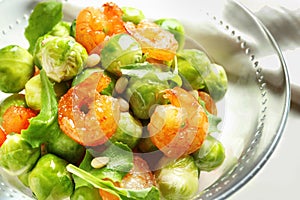 Bowl of delicious salad with Brussels sprouts and shrimps