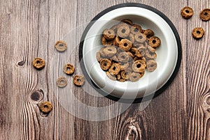 A bowl of dog food on a wooden floor