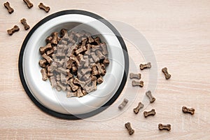 A bowl of dog food on a wooden floor