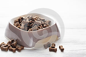 A bowl of dog food on a wooden floor