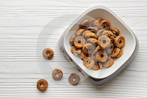 A bowl of dog food on a wooden floor