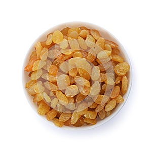 Bowl with dried golden raisins isolated on white, top view.