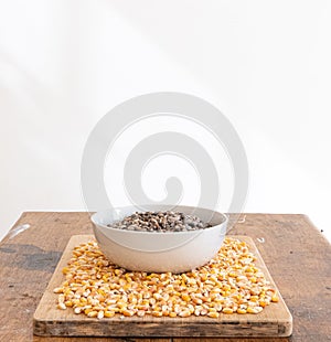 Bowl with dry beans in it and dry corns around