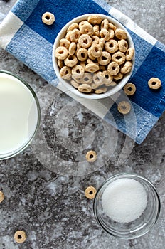 Bowl of Dry Oat Cereal and Glass of Milk