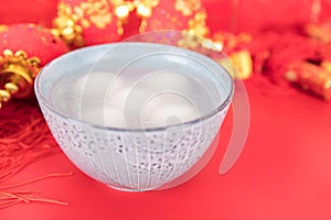 A bowl of dumplings on the red background