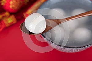 A bowl of dumplings or Yuanxiao on a red background