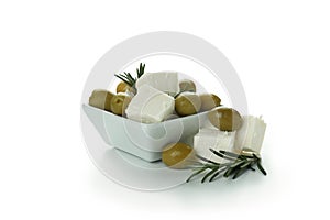 Bowl with feta cheese, olives and rosemary isolated on white background